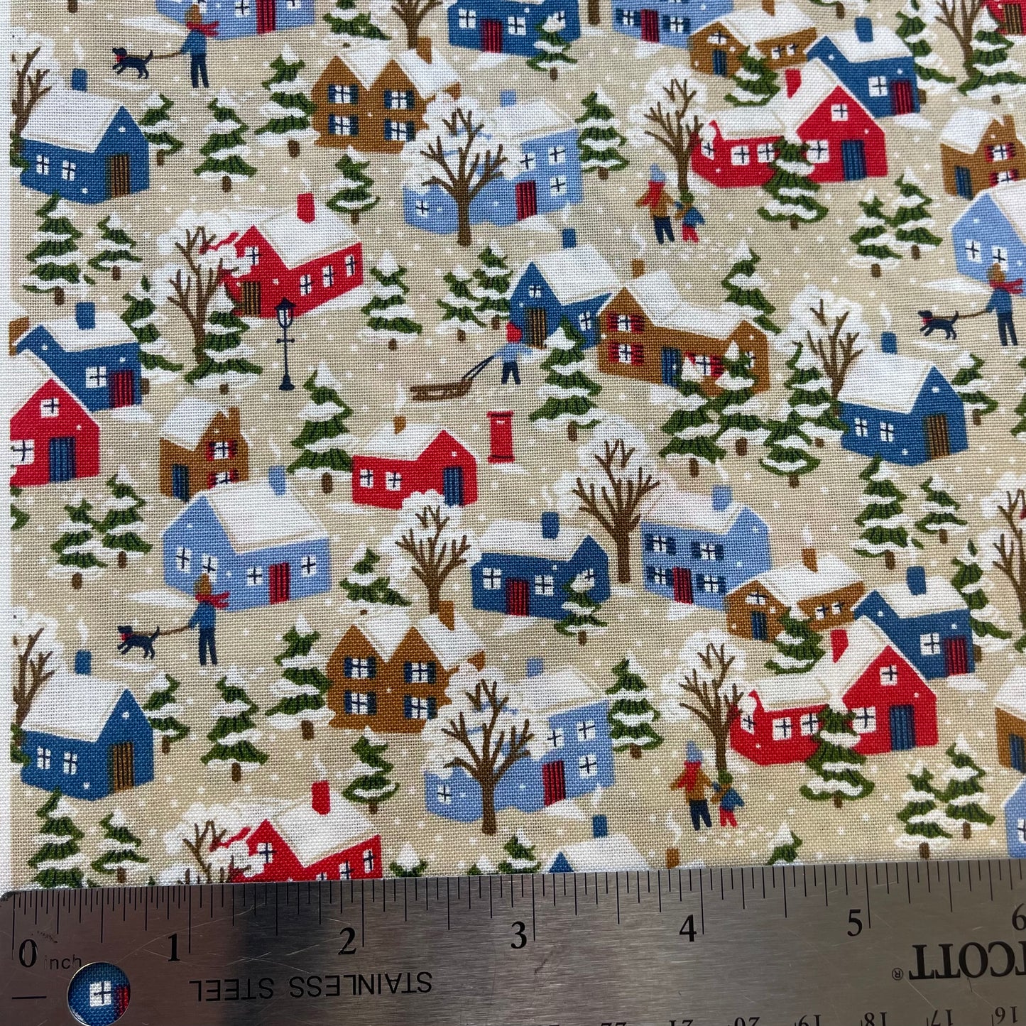 Fabric with winter snowy houses design from Liberty of London for sewing quilting and crafting.