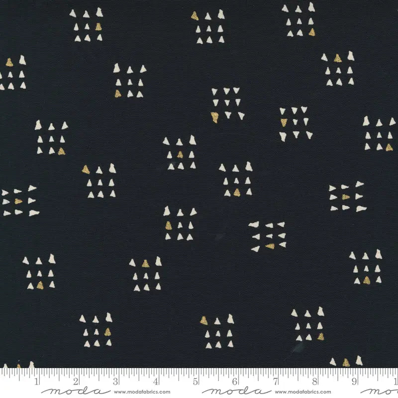 Fabric with a black background and white and metallic gold triangle illustrations. 100% Cotton canvas for sewing and crafting.