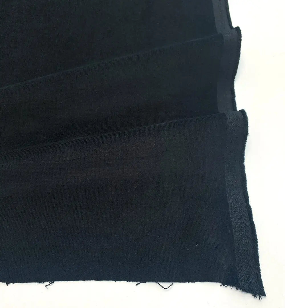 Picture of black stretch fine wale corduroy fabric for sewing. 