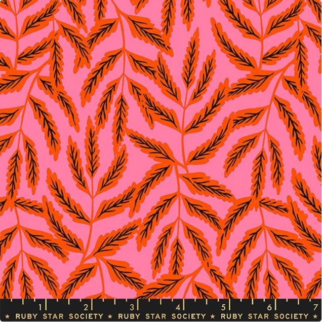 Fabric with a bright pink background and orange and black leaf pattern