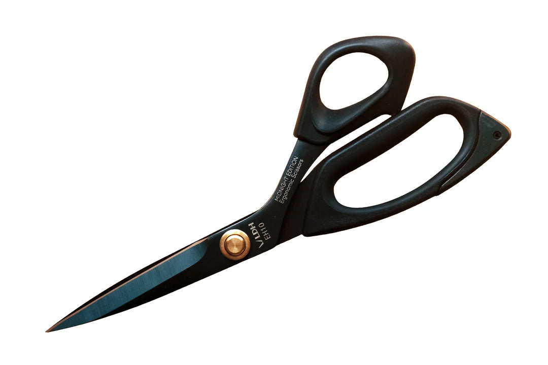 Black-handled scissors with a gold accent on a white background