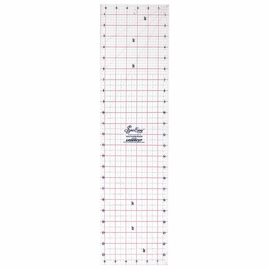 Ruler for cutting fabric rotary cutter with grid lines and measurements on a white background