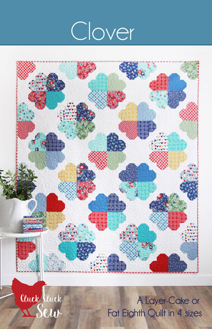 Quilt pattern with colorful clover designs on a white background