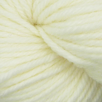Close-up of a ball of cream-colored yarn on a light beige background