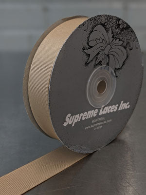 Spool of beige grosegrain ribbon for crafting and decorating 