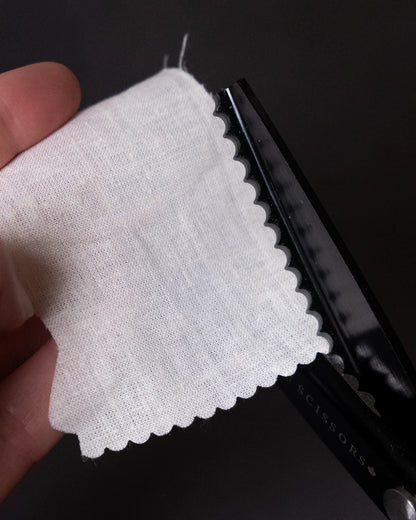 close of up pinking shears cutting fabric