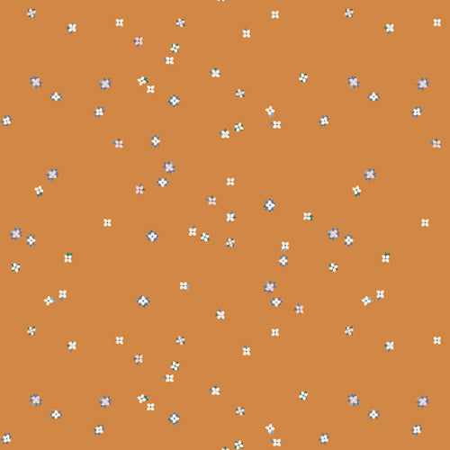 A repeating pattern of small white and light blue floral motifs scattered across a warm terracotta orange background. From the fabric line Barcelona by Katarina Roccella for Art Gallery Fabrics.