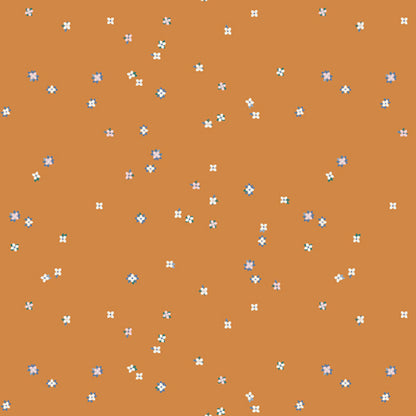 A repeating pattern of small white and light blue floral motifs scattered across a warm terracotta orange background. From the fabric line Barcelona by Katarina Roccella for Art Gallery Fabrics.