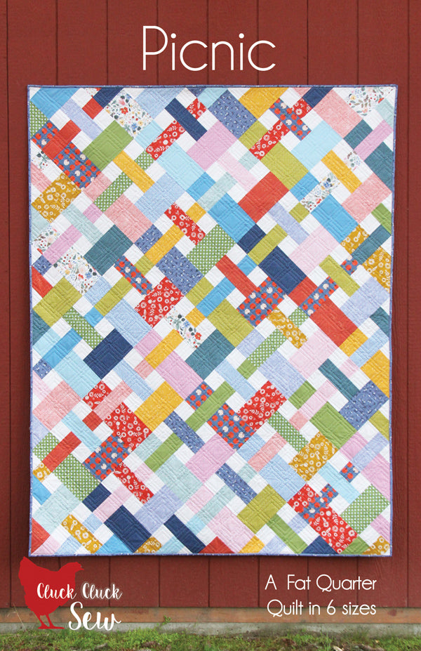 Colorful quilt pattern with geometric design on a red background, featuring the brand 'Cluck Cluck Sew'.