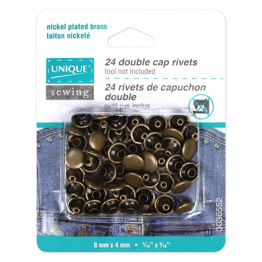 Packaging of nickel-plated brass double cap rivets by Unique Sewing on a white background.