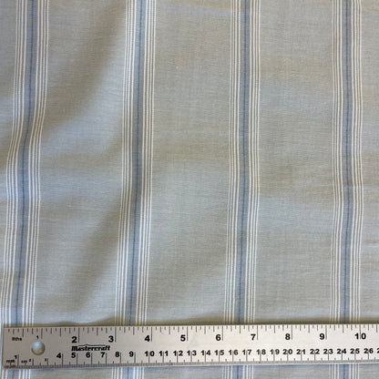 Striped blue cotton fabric with a ruler at the bottom for scale