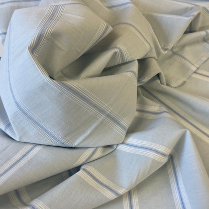 Folded cotton fabric with blue and white stripes for sewing garments
