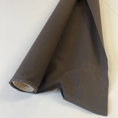 A close-up of dark brown waxed canvas fabric material for sewing and crafting and bag making.