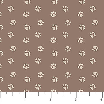 Quilting cotton fabric with a pattern of paw prints on a brown background