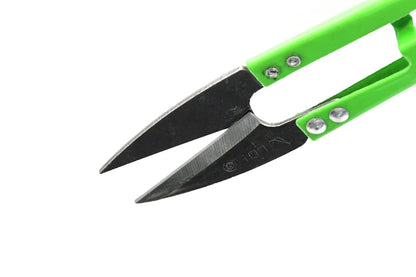 Green-handled thread snips with metal blades on a white background