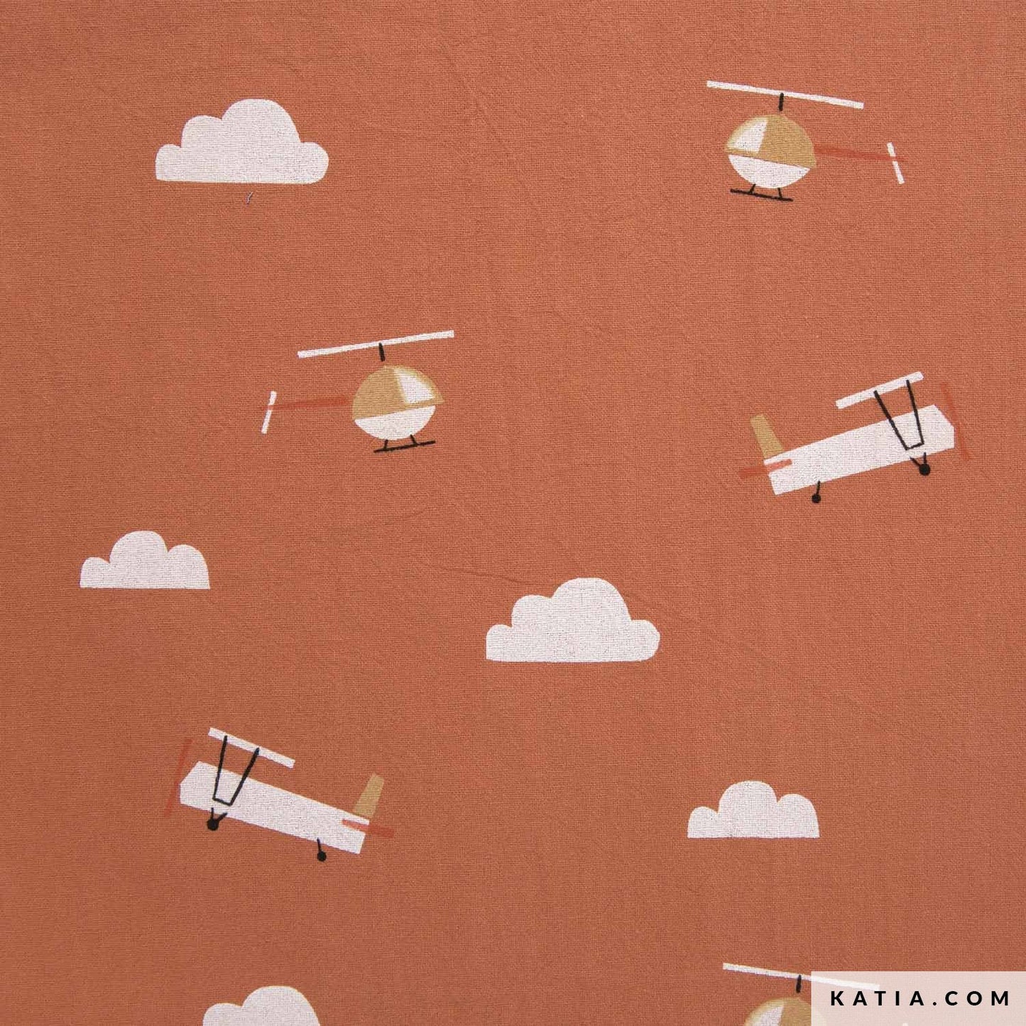 Close up of 100% cotton fabric for sewing children's clothing in orange with planes 