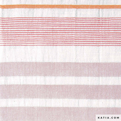 Close up of cotton fabric with pink and orange stripes for sewing and crafting. 