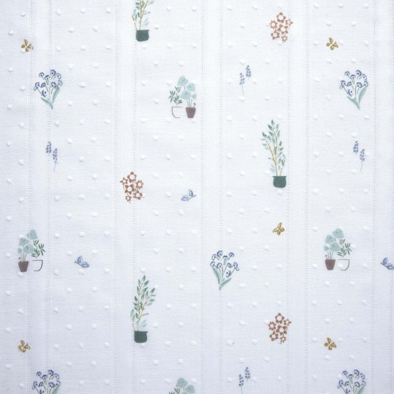 White embroidered cotton fabric with small plants and flowers