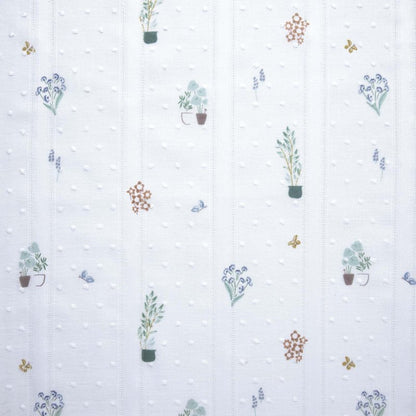White embroidered cotton fabric with small plants and flowers