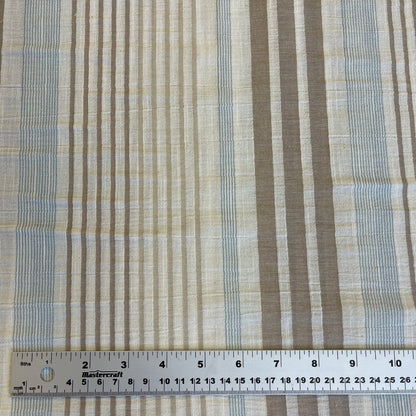 Textured fabric with stripes and a ruler at the bottom for scale.