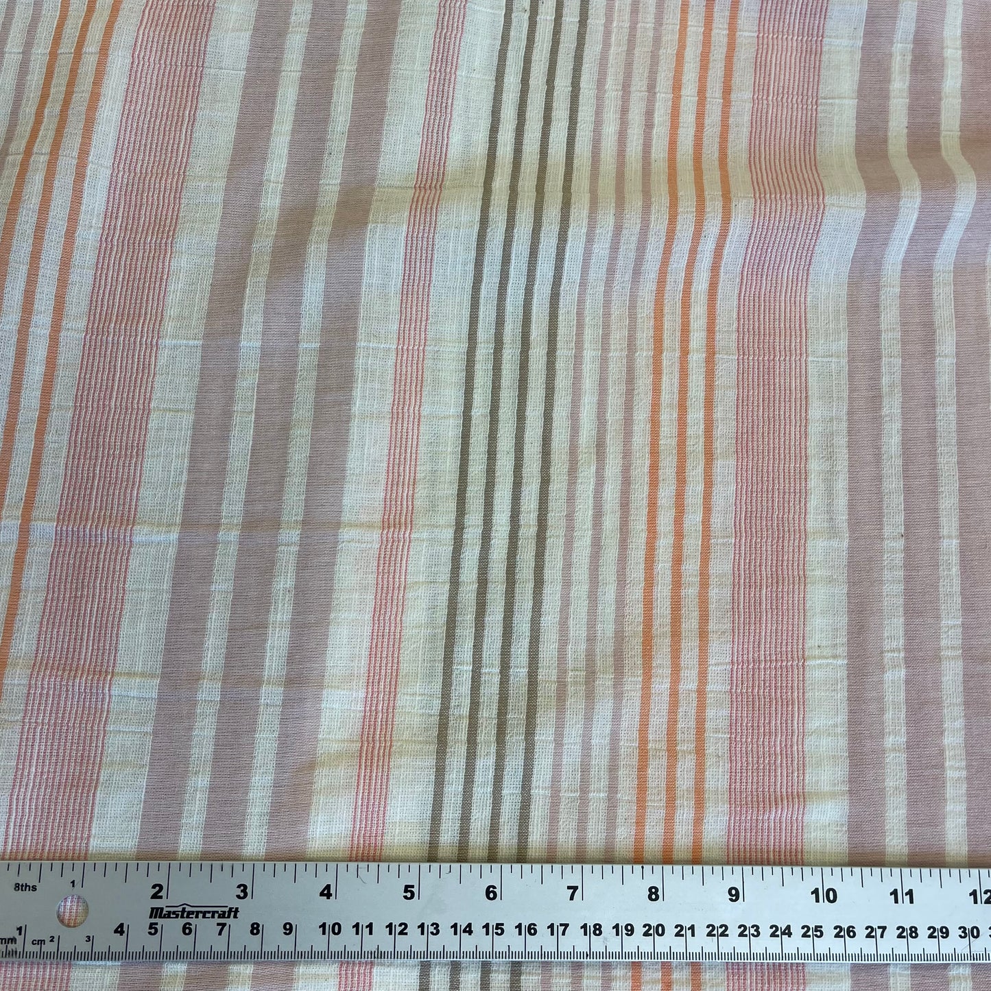 Striped fabric with a ruler at the bottom for scale