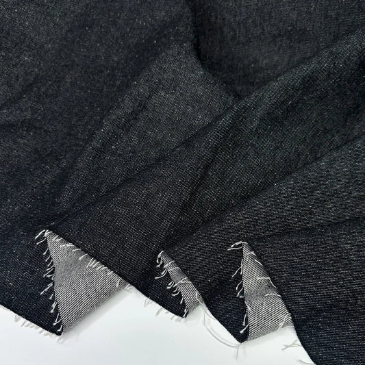 Close-up of a black f100% cotton denim fabric for sewing. 