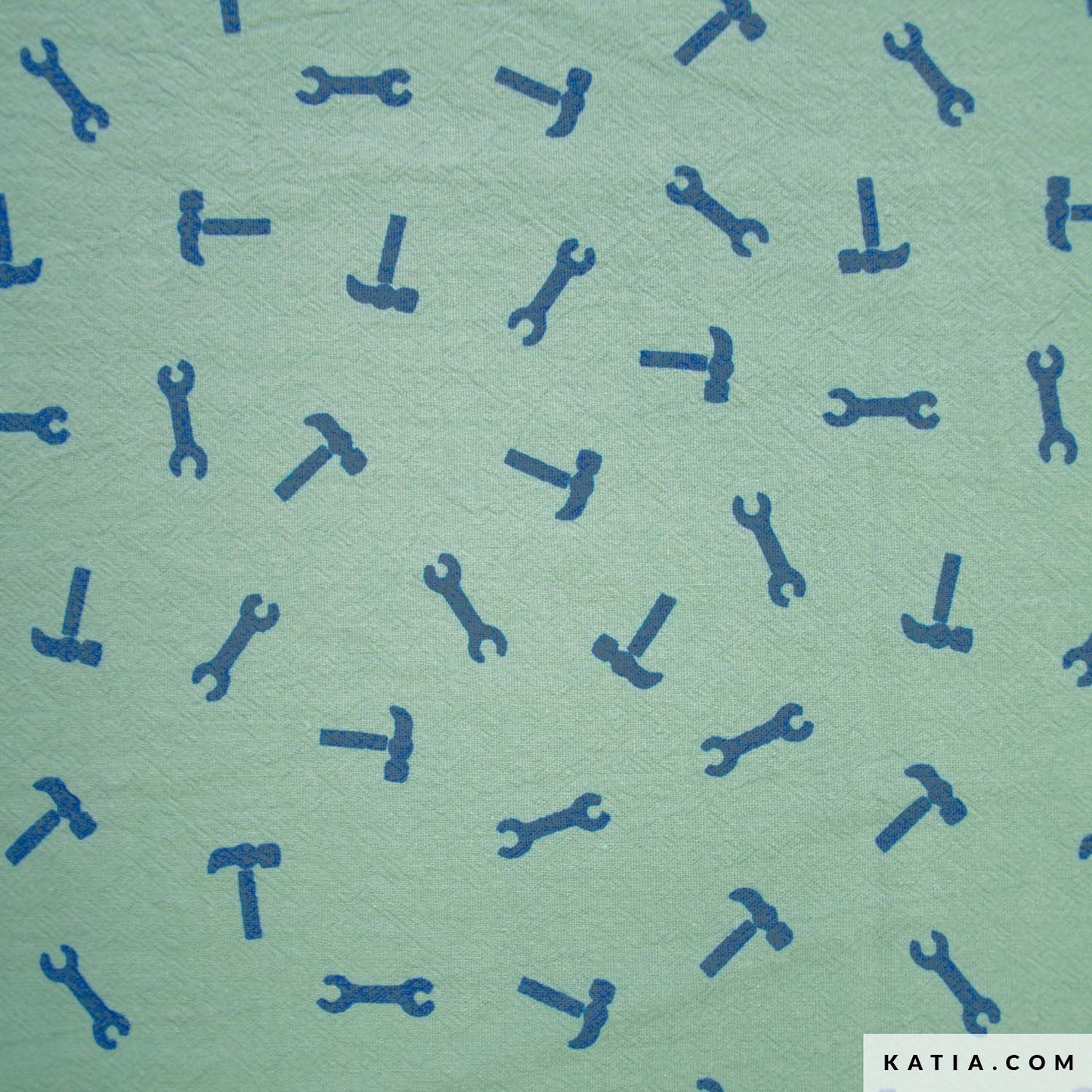 Cotton fabric with a pattern of blue tools on a green background with 'KATIA.COM' branding.
