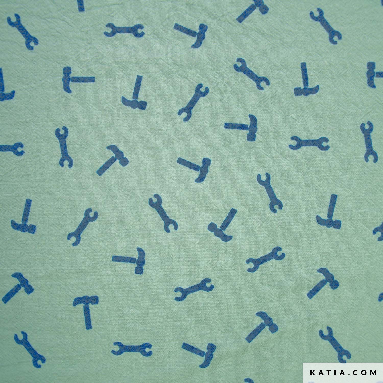 Cotton fabric with a pattern of blue tools on a green background with 'KATIA.COM' branding.