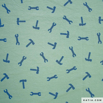 Cotton fabric with a pattern of blue tools on a green background with 'KATIA.COM' branding.