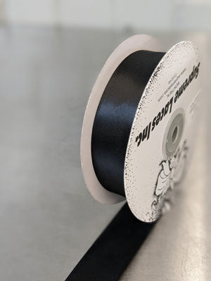 Spool of black double face ribbon for crafting and decorating 