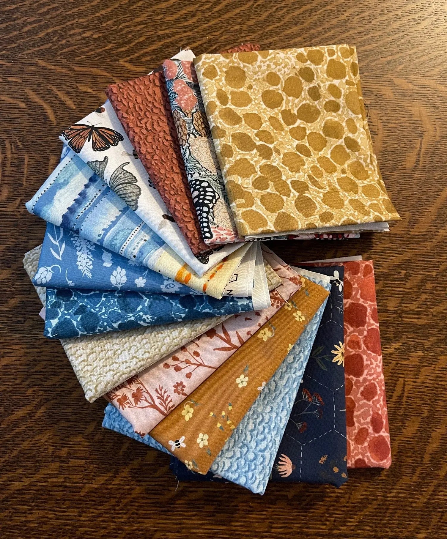 A selection of 13 piece fat quarter bundle in various colors and patterns, designed for arts and crafts. from FIGO Fabrics Eden line by Boccaccini Meadows