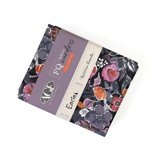 A bundle of 16 fat quarters with an floral pattern, halloween themed, predominantly in purple and black colors, labeled 'Eerie' by AGF Studio.
