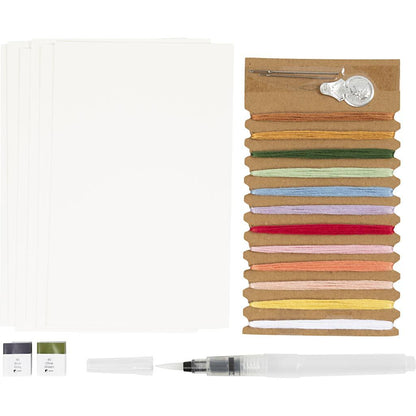 Set of colorful ribbons with a pen and small containers on a white background