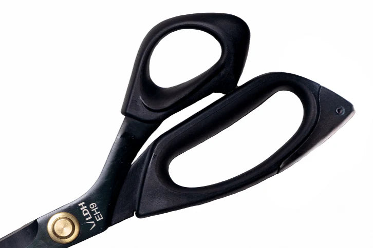 Black scissors with gold accents on a white background