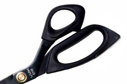 Black scissors with gold accents on a white background