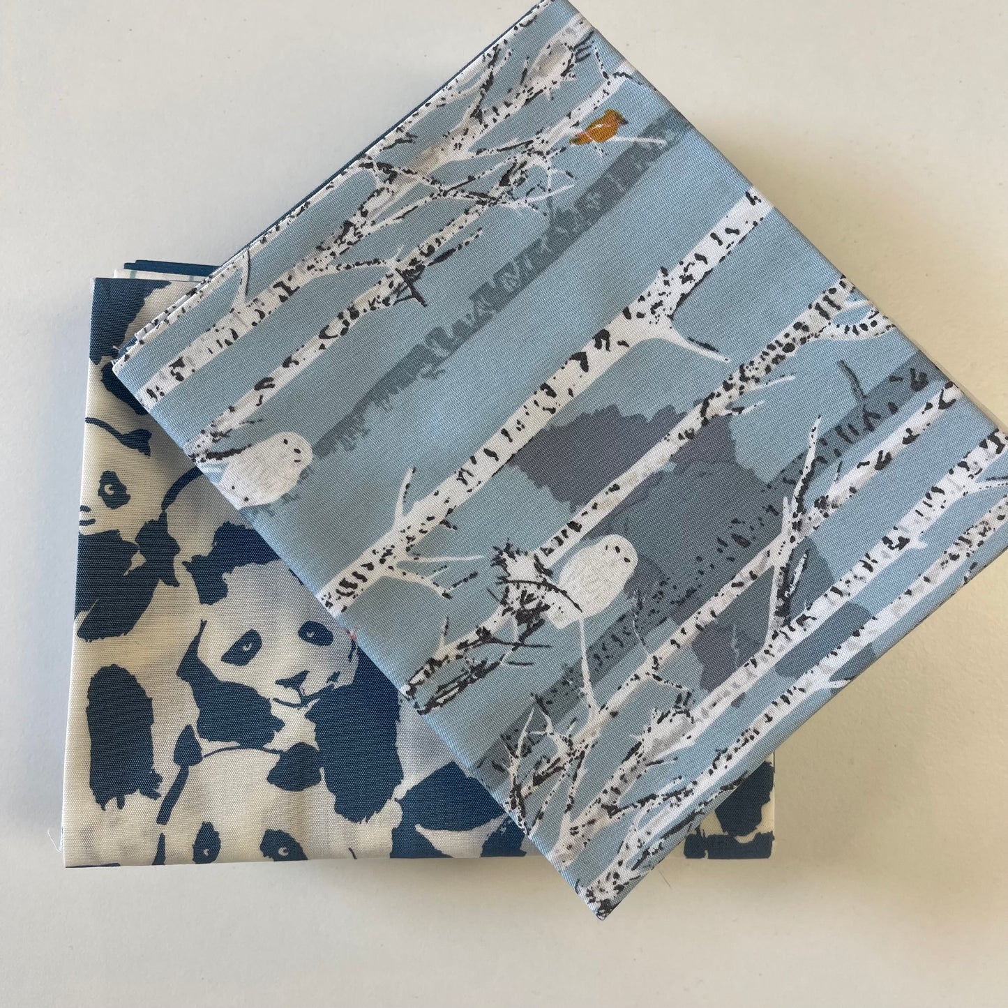 close up of fat quarter bundle pieces in blue theme for sewing and quilting