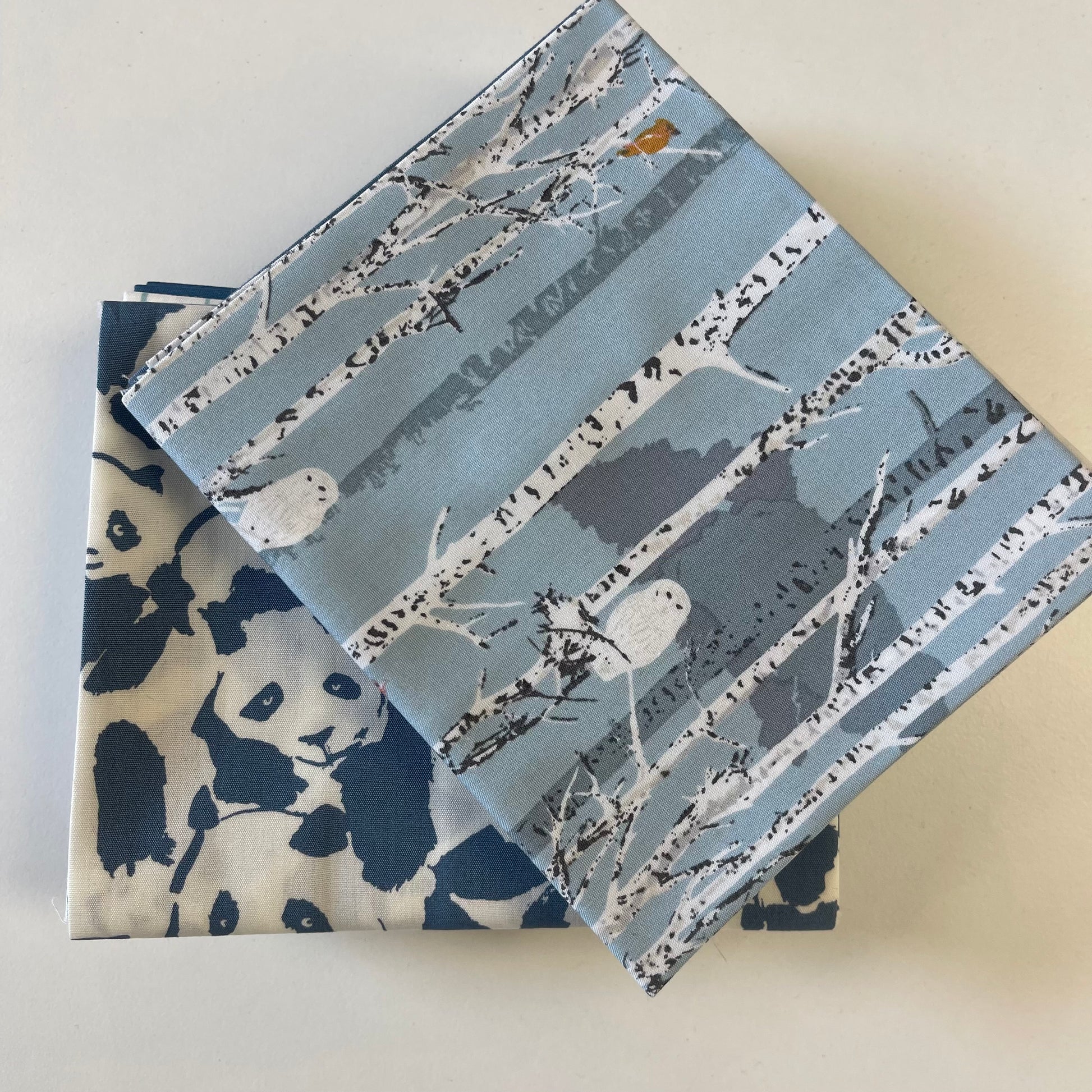close up of fat quarter bundle pieces in blue theme for sewing and quilting