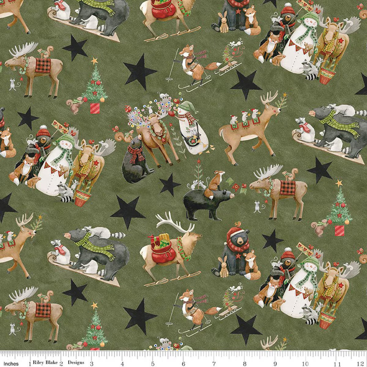 Christmas-themed fabric with animals and stars on a green background, ruler at the bottom.