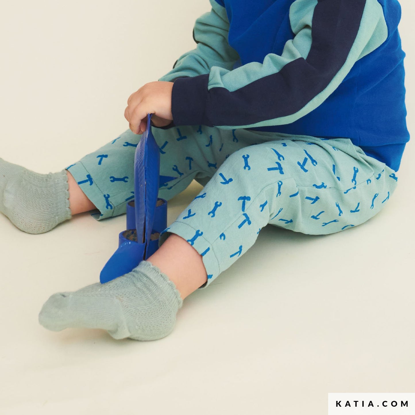 Child wearing blue and green pants made from cotton.