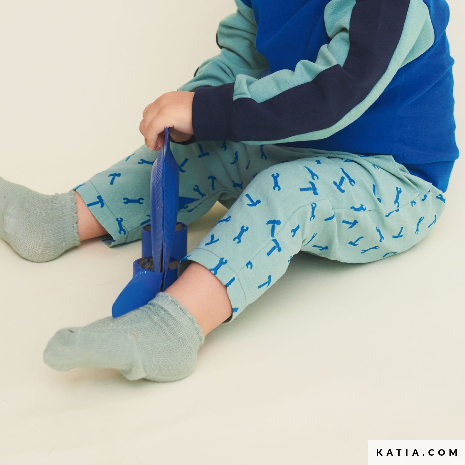 Child wearing blue and green pants made from cotton.