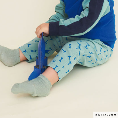 Child wearing blue and green pants made from cotton.