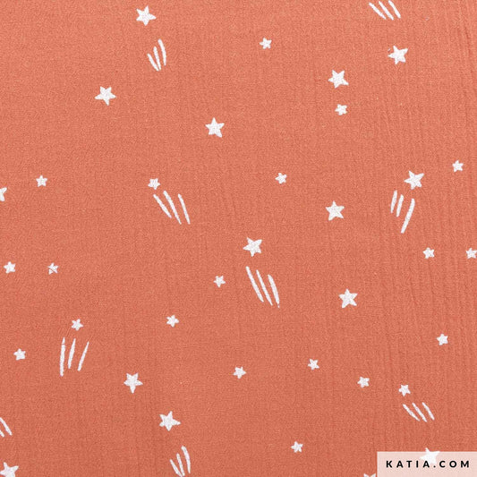 Cotton double gauze fabric with white stars and lines on a coral background with 'KATIA.COM' branding.