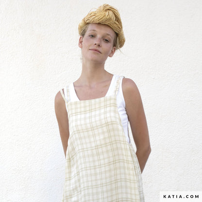 woman wearing a beige checked overall from muslin fabric.