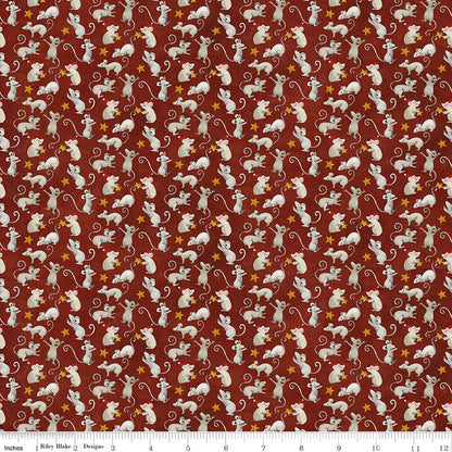 Patterned fabric with small white mice and yellow stars on a red background, with a ruler at the bottom.