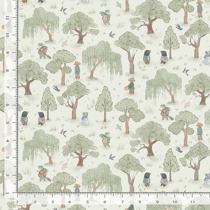Fabric with a pattern of trees and people in a forest, with a ruler for scale.