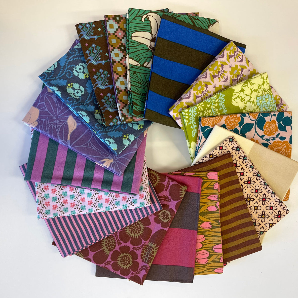 A stack of vintage inspired fat quarter fabrics for sewing and quilting, from Anna Maria Textiles. 