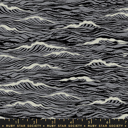 A close-up of a fabric pattern featuring wavy, zebra-like black and gray stripes with off-white highlights, with a Ruby Star Society ruler visible at the bottom edge.