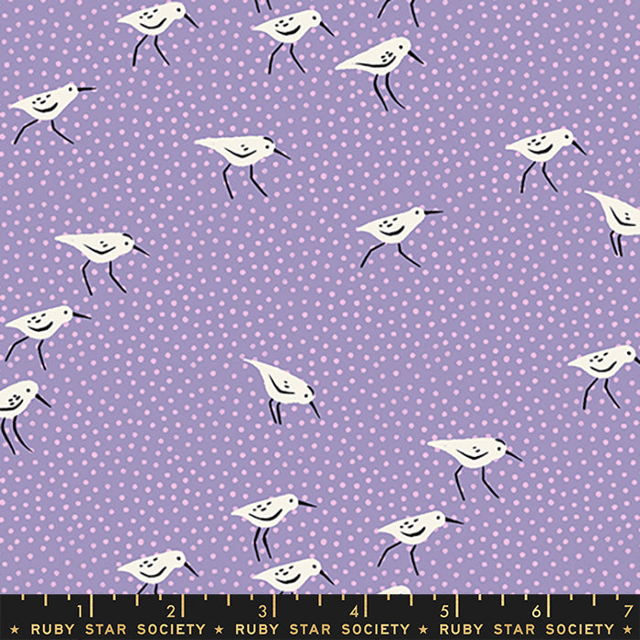 A repeating fabric pattern featuring white sandpipers with black beaks and legs on a light purple background with small white polka dots. A black measurement scale bar with 'RUBY STAR SOCIETY' text is visible along the bottom edge.