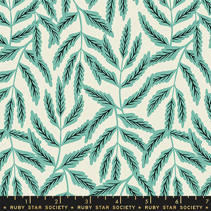 Fabric with a repeating botanical pattern of teal and dark green leafy stems on a warm cream background, with a black ruler strip along the bottom edge labeled Ruby Star Society.