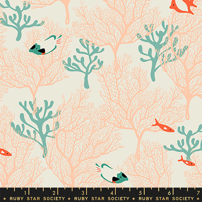 A repeating fabric or wallpaper pattern featuring coral reef silhouettes in peach, teal anemones, and small orange fish on a warm cream background. A black ruler strip labeled Ruby Star Society appears along the bottom edge.